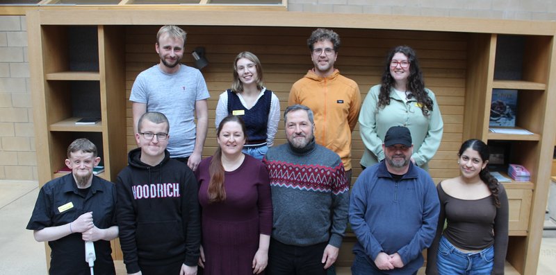 photo of ten people arranged in two rows, everyone is smiling and looking fabulous