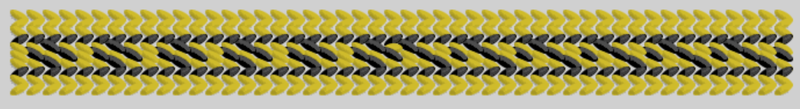 A pattern in black threads runs in the middle of a yellow tablet weaving, starting with a meander and ending up with diamonds with dots in the middle. From the Oseberg ship burial, Vestfold, Norway made shortly before 834 AD