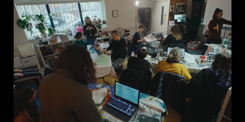 A room of people, laptops, glue guns, motors and lollypop sticks. They're making handmade robots and controlling them with code.